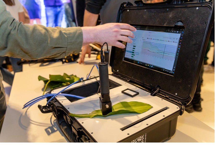 LENS unit scanning a leaf with results displayed on the connected laptop